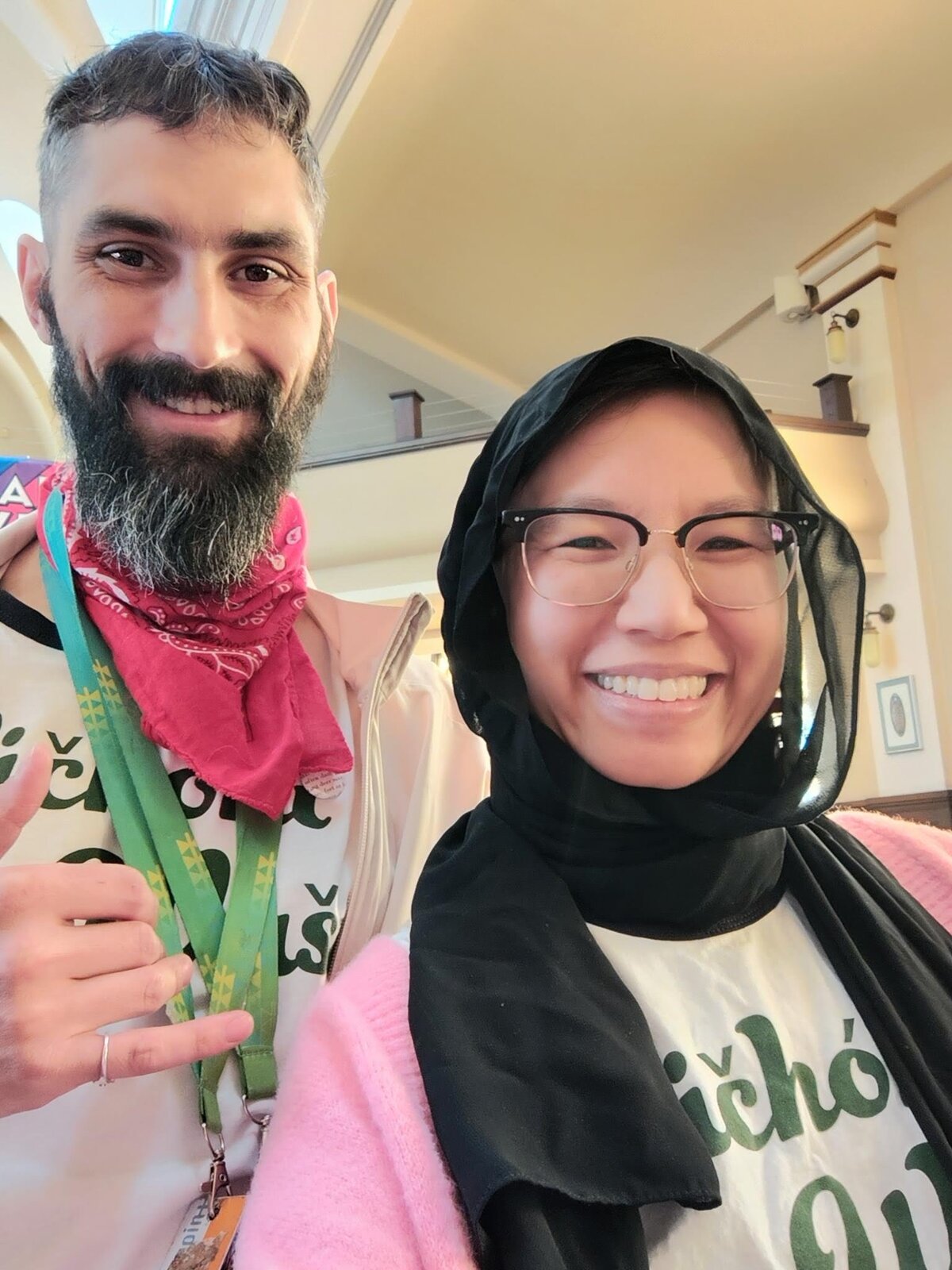 Hannah Frelot and Cody Lestelle in Wičhóni Wašté shirts and green ribbon lanyards